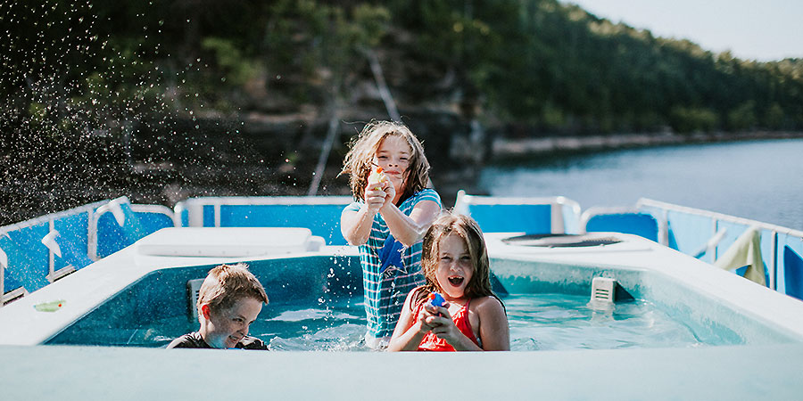 Kids playing with water guns in the spacious hot tub.