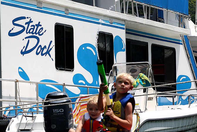 Children playing with water guns aboard the Voyage houseboat