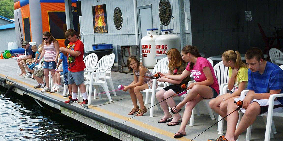 Kids and parents fishing off the dock