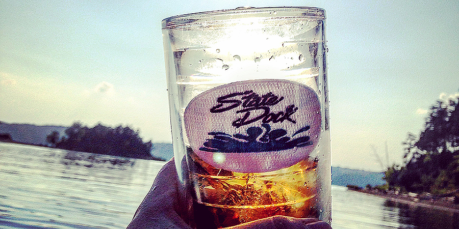 A ice cold drink in a state dock branded glass.