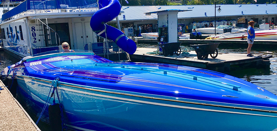 Pretty blue speed boat preparing to leave the dock.