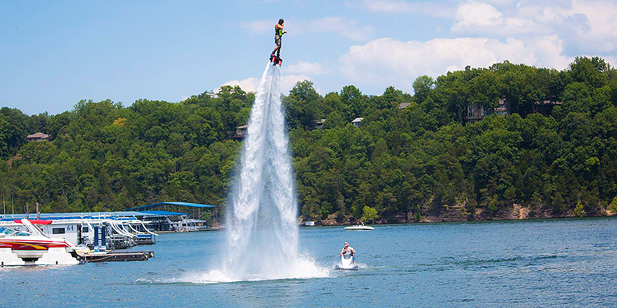 Guy being blasted into the sky on water jet.